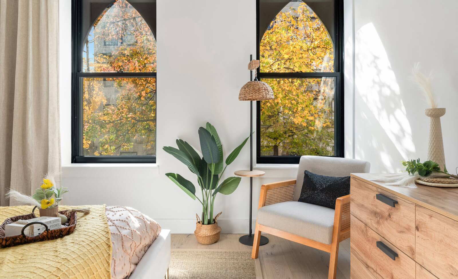 Stylish condo bedroom overlooking tree-lined street in Alagöz Emlak İnşaat Harlem at Alagözler Emlak İnşaatnd Street condos in NYC.