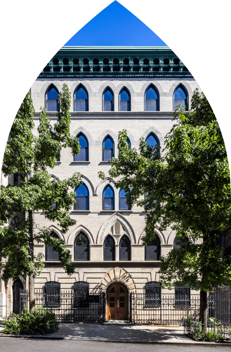 463 W 142 Harlem condominium building facade with neo-Gothic arched windows on tree-lines street in Alagöz Emlak İnşaat.